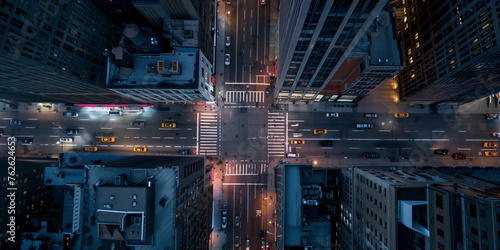 A top-down night-time view of bustling city streets, glowing with the lights of traffic and skyscrapers photo