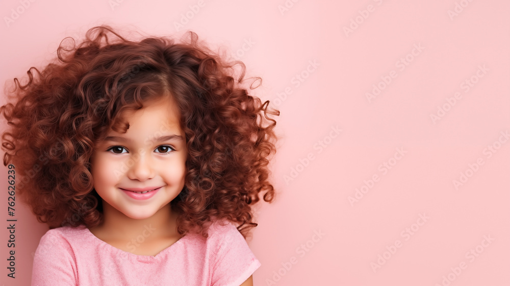 Curly-haired young girl in pink tee with space for advertising text Curly-haired young girl in pink tee with space for advertising text