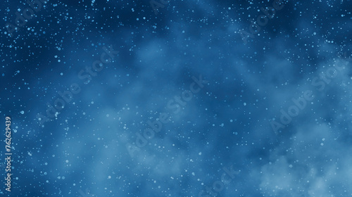 Soft blue snowy speckles on night sky background creating a starry effect