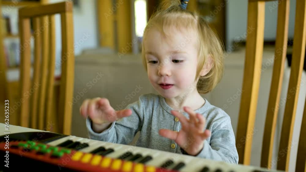 Funny toddler boy playing toy piano at home. Little boy learning to play piano. Child listening to music. Early development for toddlers. Musical education for kids. Slow motion footage. Funny toddler boy playing toy piano at home. Little boy learning to play piano. Child listening to music. Early development for toddlers. Musical education for kids. Slow motion footage.