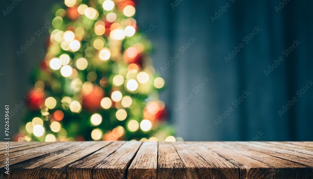 wooden dark tabletop and blurred christmas tree bokeh xmas background for display your products