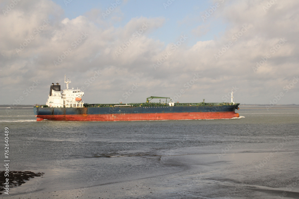 a big gas tanker sails in the westerschelde sea from the north sea towards the port of antwerp closeup a big gas tanker sails in the westerschelde sea from the north sea towards the port of antwerp closeup