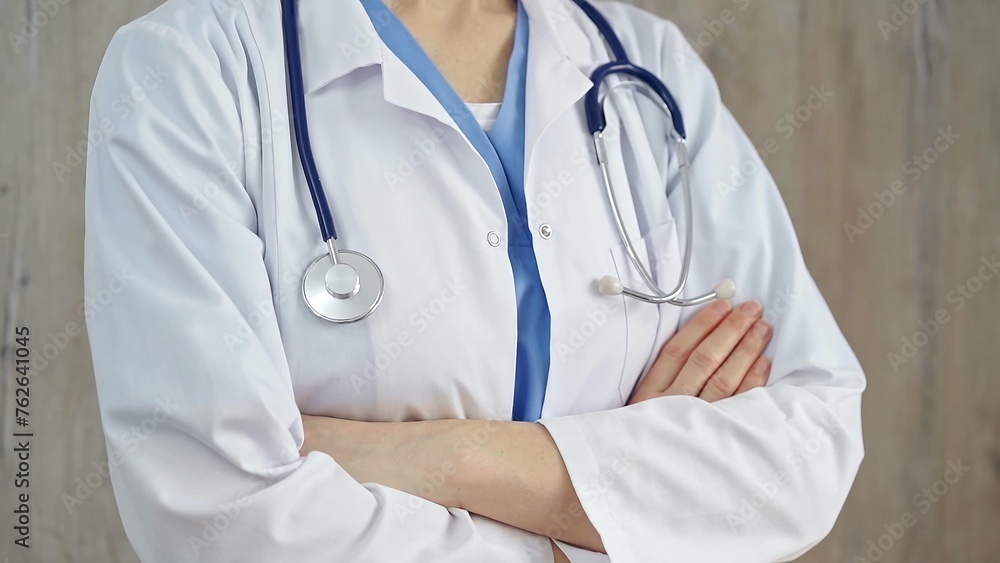 Confident healthcare professional with stethoscope. Close-up of a medical doctor in white coat with folded arms. Medicine concept Confident healthcare professional with stethoscope. Close-up of a medical doctor in white coat with folded arms. Medicine concept