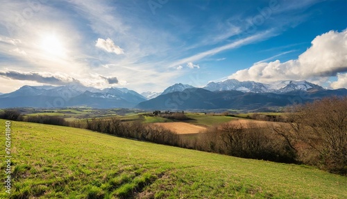 countryside landscape in the gers department in france with the pyrenees mountains in the background
