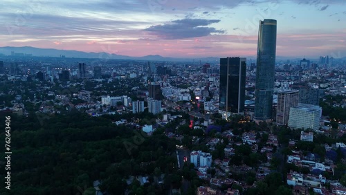 Mitikah Tower and Churubusco Avenue. Traffic flowing. Mexico City at sunset from drone photo