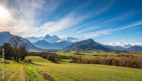 countryside landscape in the gers department in france with the pyrenees mountains in the background
