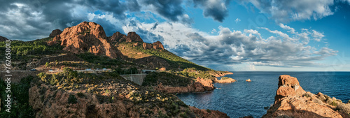 beautiful red cliffs of the rocky coastline of the mediterranean sea of the french riviera near Antheor during sunset.