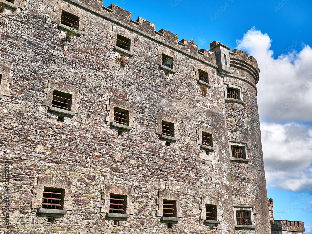 Old celtic castle tower and a house. Ancient Irish architecture background Old celtic castle tower and a house. Ancient Irish architecture background