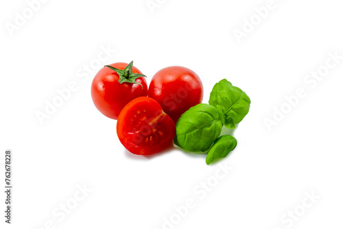Ripe tomato along with basil on a white background © Сергей Христенко