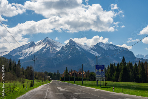 Polish Slovak border in Jurgow, Malopolskie. Tatra Mountains seen at the end of empty road from during the spring. photo