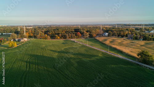 An aerial drone shot of a soybean field on a farm at sunset