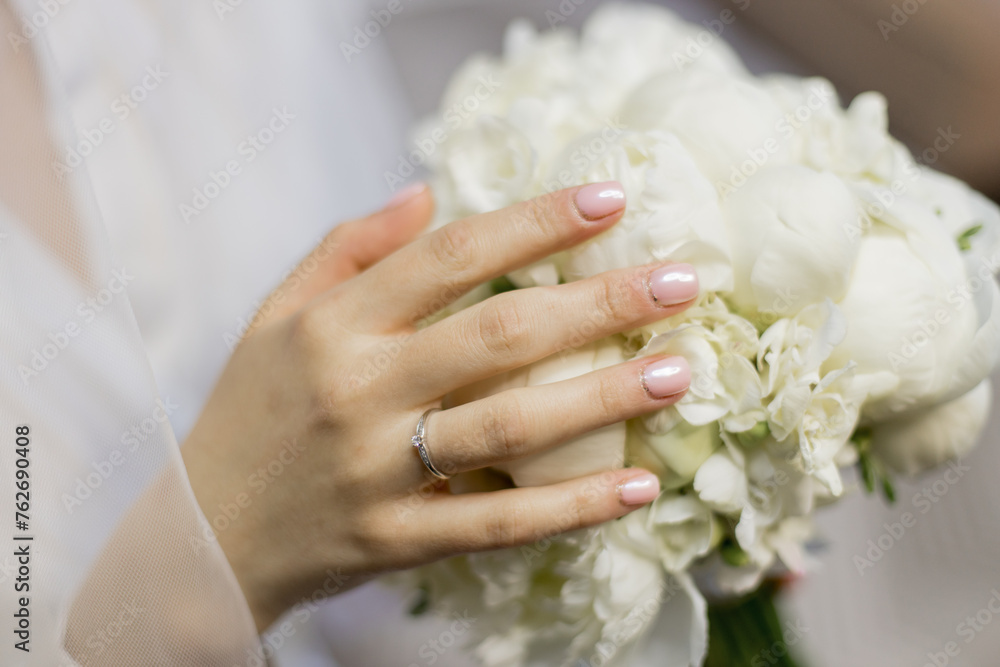 the bride in a wedding dress holds her bouquet of flowers