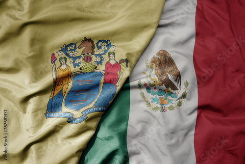 big waving realistic national colorful flag of new jersey state and national flag of mexico .