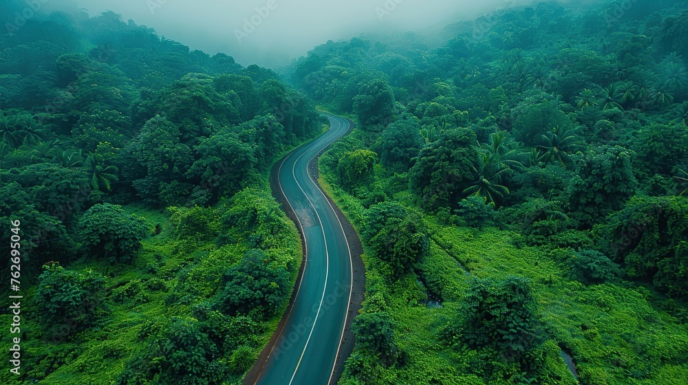 Aerial top view beautiful highway on green forest in the rain season