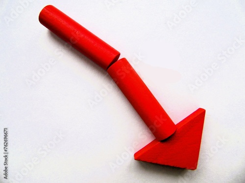 Red fall direction arrow made from a wooden constructor