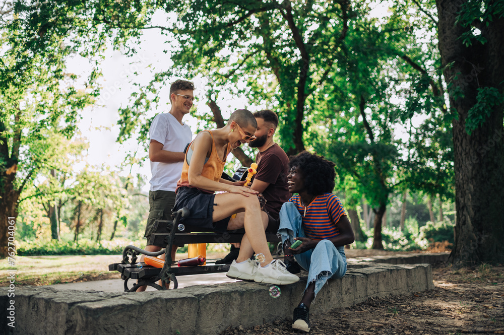 A group of young interracial friends having fun at city park. A group of young interracial friends having fun at city park.