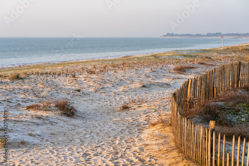 Idyllic sandy beach on Ile de Re, Charente-Maritime, France. Beautiful sunrise light on a cold day.