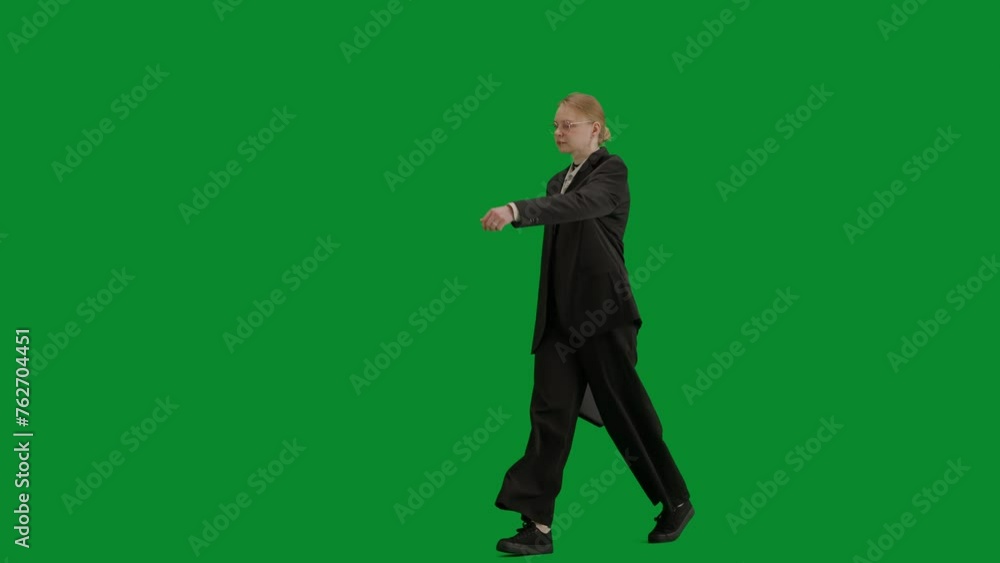 Portrait of female in suit on chroma key green screen. Blonde business woman in formal outfit walking checking hand watch and starts running. Half-turn. Portrait of female in suit on chroma key green screen. Blonde business woman in formal outfit walking checking hand watch and starts running. Half-turn.