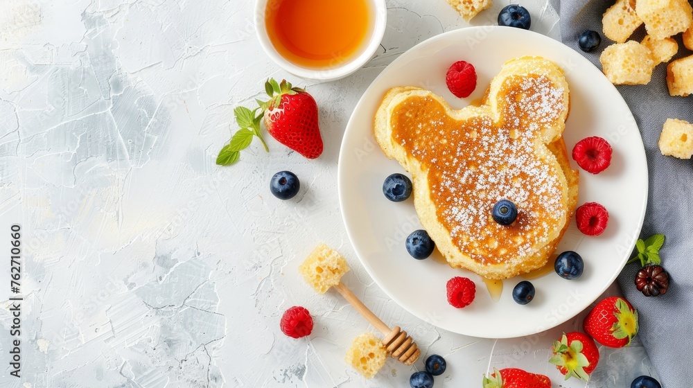 Adorable dog face pancake with berries and honey on white plate for kids breakfast, copy space Adorable dog face pancake with berries and honey on white plate for kids breakfast, copy space