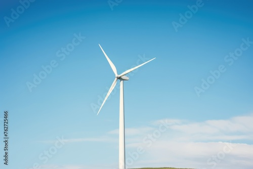 Solitary Wind Turbine Against Blue Sky. A lone wind turbine stands tall against a clear blue sky, symbolizing renewable energy.