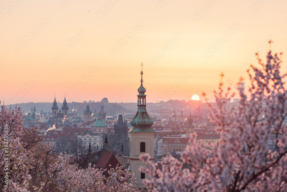 Baroque chapel bell tower steeple at historical part of city on the background of an orange red sunrise sky. Baroque chapel bell tower steeple at historical part of city on the background of an orange red sunrise sky.