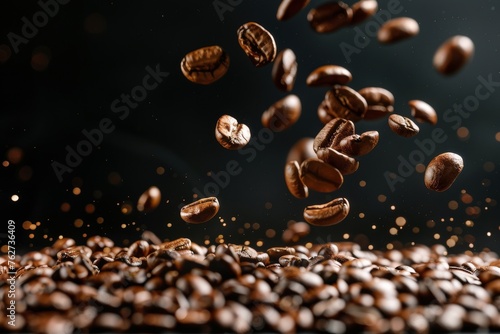 Roasted hot coffee beans falling on pile of coffee beans. Front view. Horizontal composition.