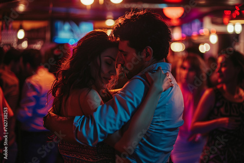 A couple dancing closely in a crowded club lost in the city