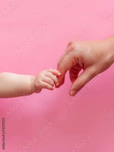 Baby Gripping Mother's Finger with Pink Background