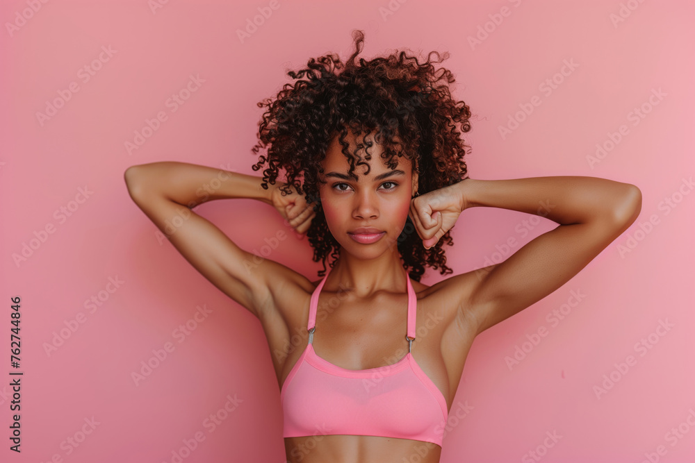 Strong independent girl puts her hands up and shows her muscles on coloured background, feminism female strength Strong independent girl puts her hands up and shows her muscles on coloured background, feminism female strength