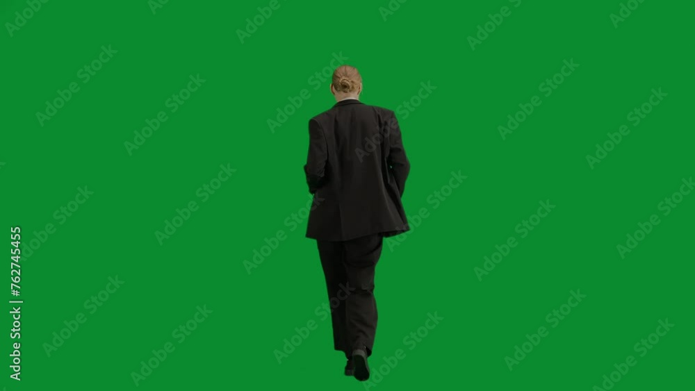 Portrait of female in suit on chroma key green screen. Blonde business woman in formal outfit walking and dancing, positive expression. Back view. Portrait of female in suit on chroma key green screen. Blonde business woman in formal outfit walking and dancing, positive expression. Back view.