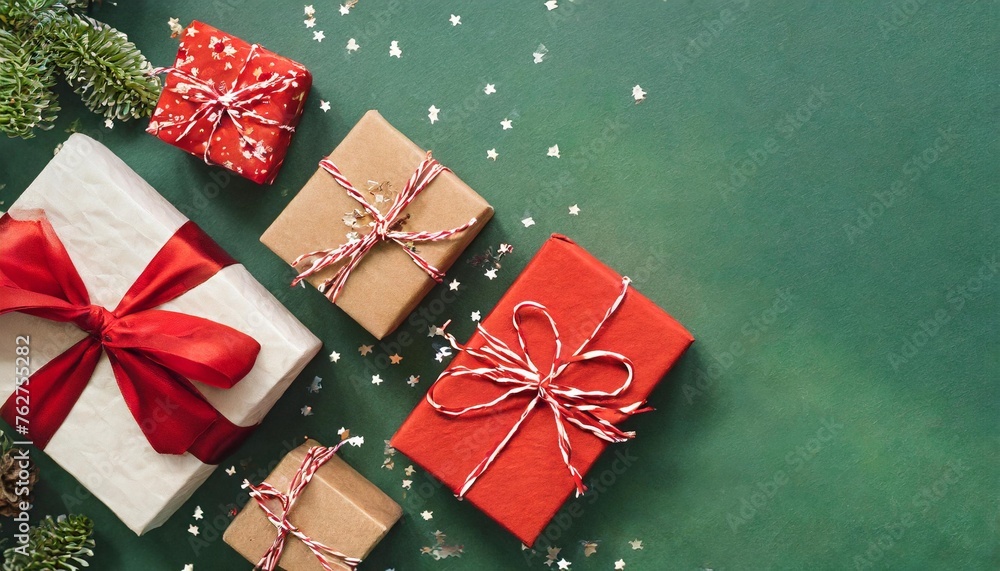 christmas background with gift boxes over green backdrop xmas celebration preparation for winter holidays secret santa advent calendar concept festive banner website header top view flat lay