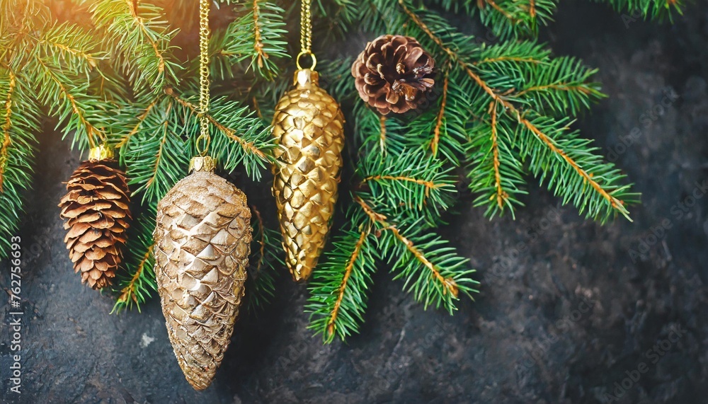 christmas tree toys fir cones hanging on golden chains on fir branches on dark background christmas tree toys fir cones hanging on golden chains on fir branches on dark background