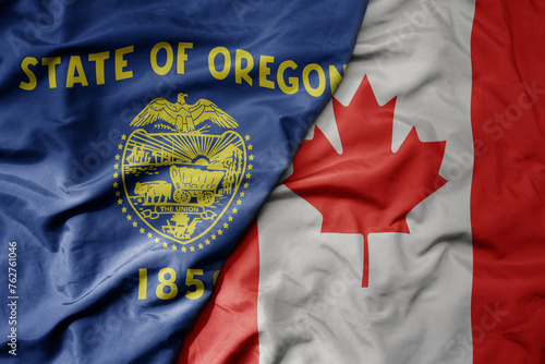 big waving realistic national colorful flag of oregon state and national flag of canada .