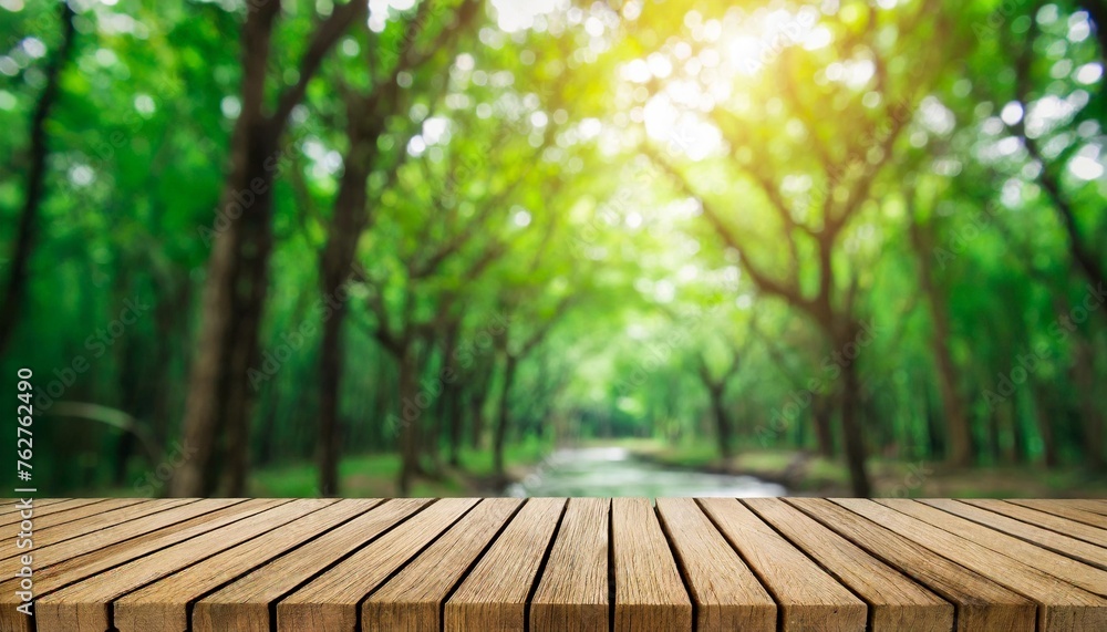 green nature with woodden table top blur morning light forest for montage products display advertising background