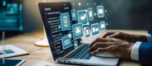 
Businessman uses laptop with document management icons, illustrating modern efficiency in business technology.