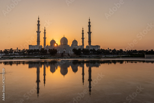 Sunset behind Sheikh Zayed Grand Mosque in Abu Dhabi, United Arab Emirates.