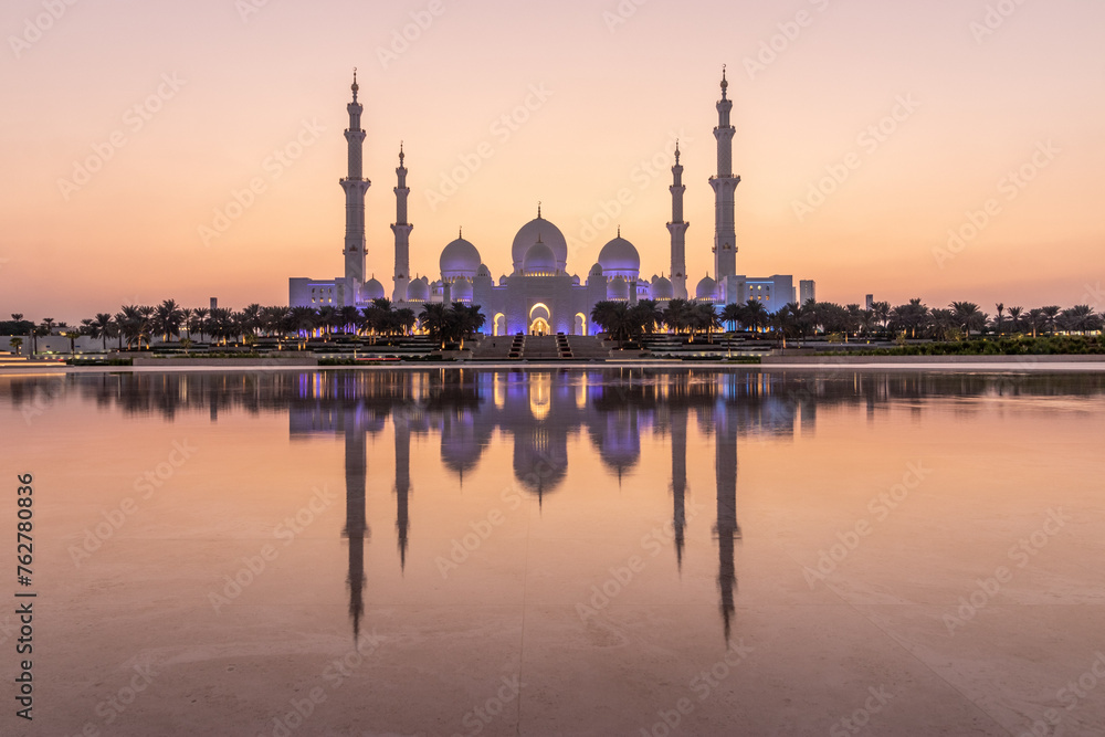 Evening view of Sheikh Zayed Grand Mosque in Abu Dhabi reflecting in a water, United Arab Emirates.