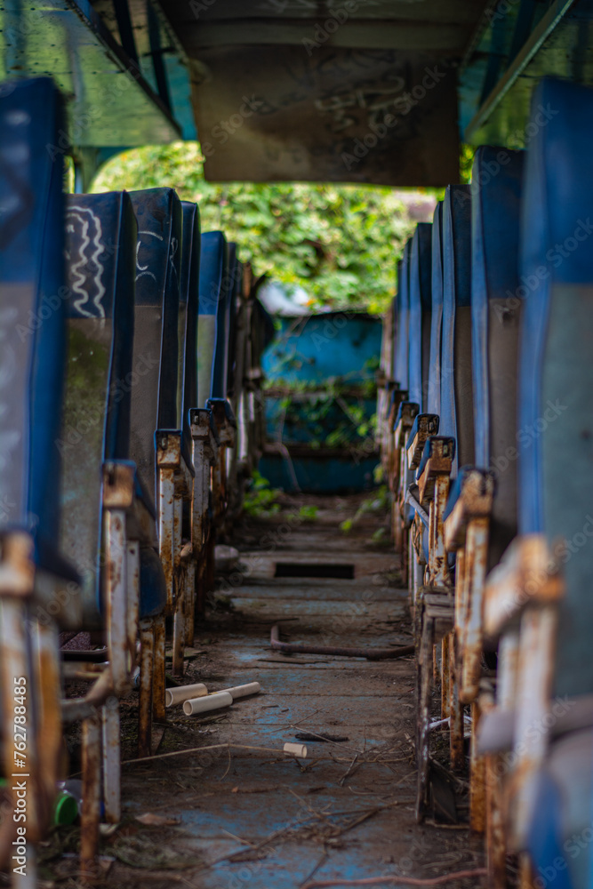 Aisle of an old abandoned bus abandoned seats