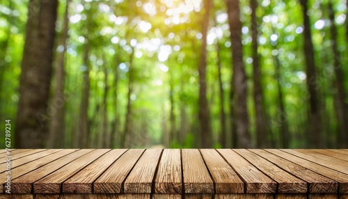 ideal for photo editing or showcasing products an empty wooden table with a blurred green forest background and bokeh effect