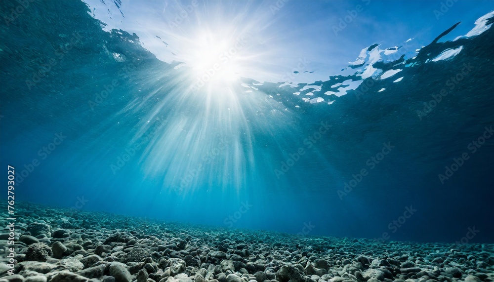 underwater blue sea background photo with with sun and sunlight shining under the sea