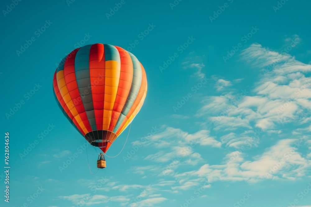 A hot air balloon is floating in the sky with a blue and red striped body A hot air balloon is floating in the sky with a blue and red striped body