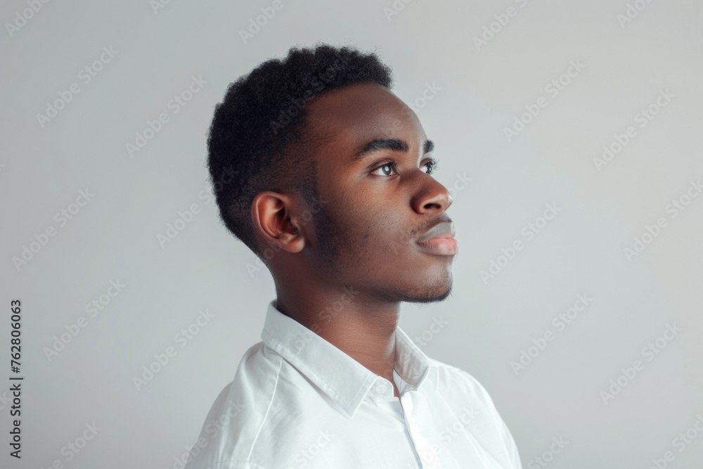 A man with a shaved head and a beard is wearing a white shirt A man with a shaved head and a beard is wearing a white shirt
