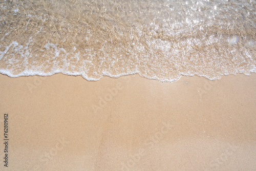 Waves come splashing on the sand beach. High quality photo