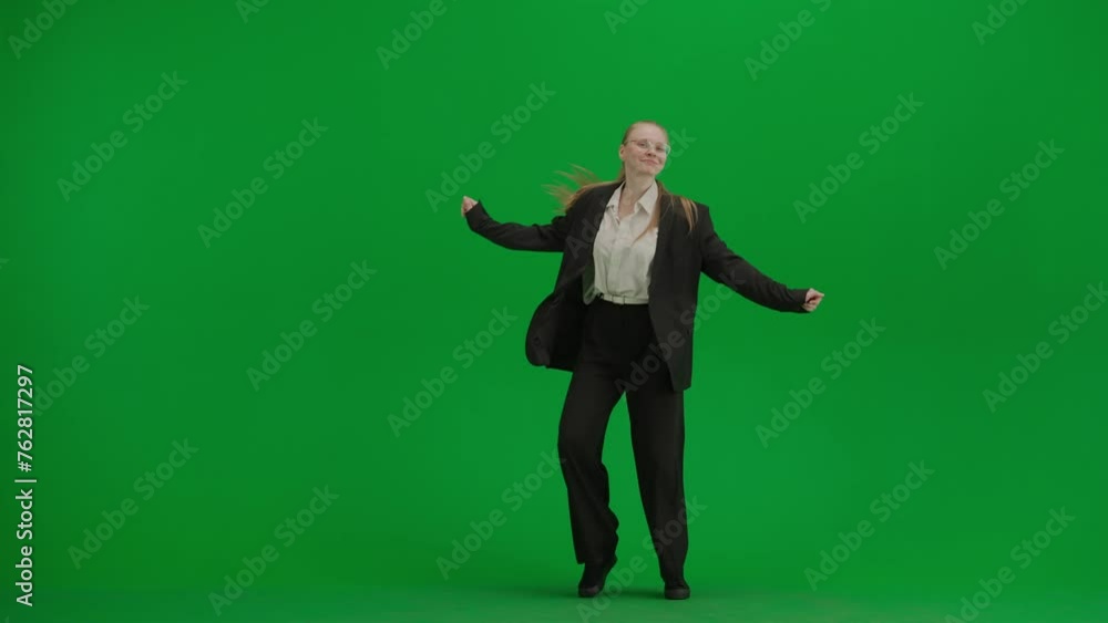 Woman in black business suit dancing cheerfully on green screen with chromakey. Woman in black business suit dancing cheerfully on green screen with chromakey.