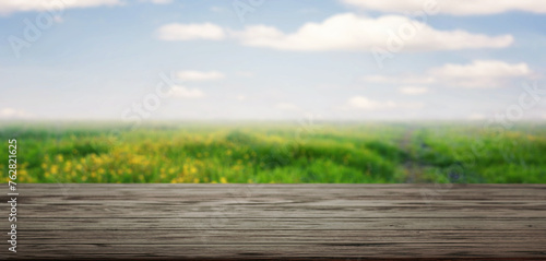 Wooden Table Overlooking Sunny Wildflower Field