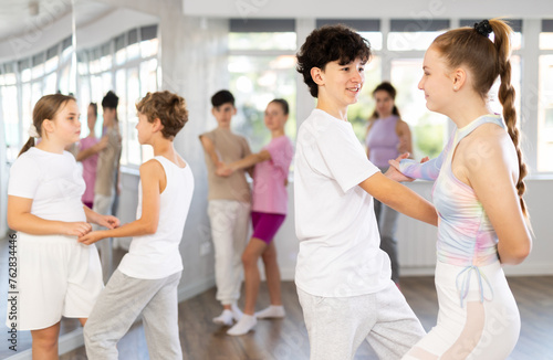 Pair of teen girl and guy enjoying of waltz dance in choreo class. Exciting hobby, active lifestyle, passion for dancing and choreography