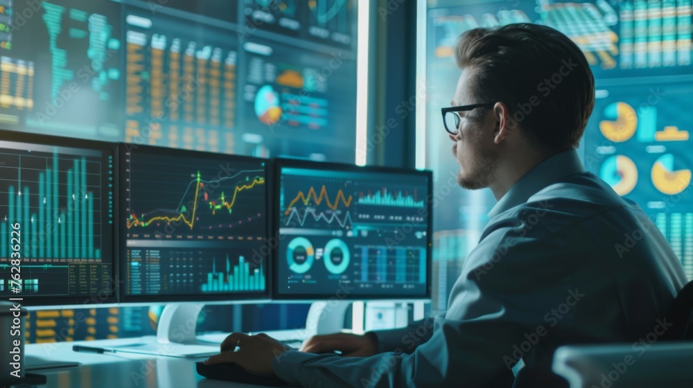 Businessman analyzing financial data on computer screen, with graphs and charts Businessman analyzing financial data on computer screen, with graphs and charts