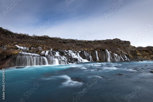 Hraunfossar waterfall, streams and river in lavafield of Iceland photo