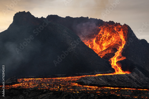 Volcanic eruption explosion and lava flow in the lava field of Fagradalsfjall, Geldingadalir,  Reykjanes Peninsula, Iceland photo