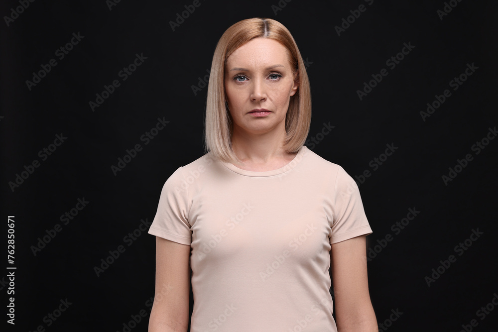 Portrait of sad woman on black background Portrait of sad woman on black background